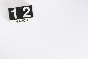 March 12th. Day 12 of month, wooden color calendar on white background. Spring time, empty space for text