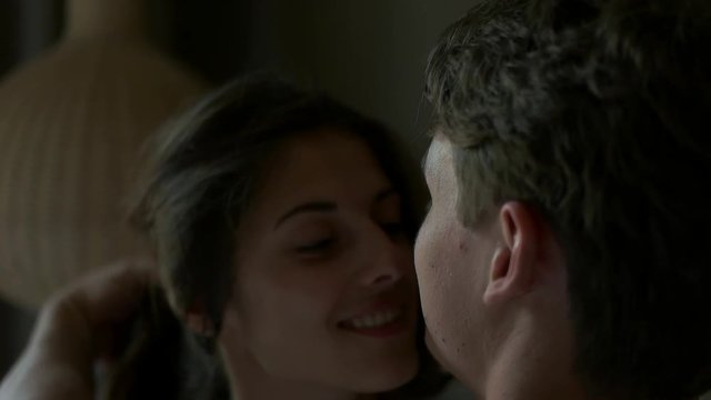 couple luxuriating on a bed.