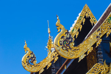 Fototapeta na wymiar Beautiful Golden Thai Lanna Architecture: Chapel Roof of Wat Inthakhin Sadue Muang, Chiangmai, THAILAND.