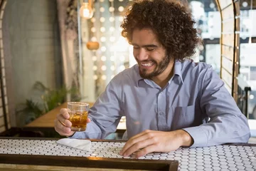  Man having glass of whisky in bar counter © WavebreakMediaMicro