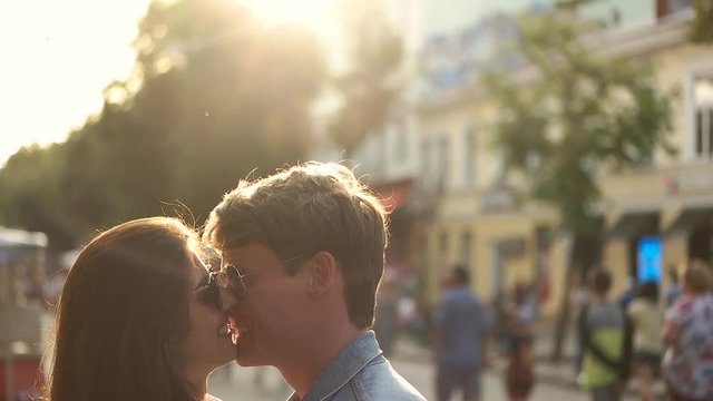 couple kissing on the street.
