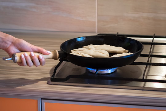 Cast Iron Pan Stands On A Gas Stove