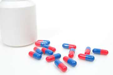 Antibiotics red and blue capsules with bowl drugs