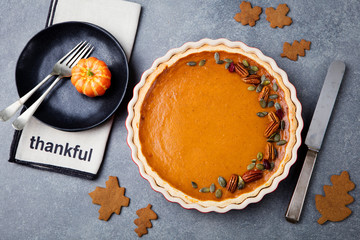 Pumpkin pie, tart in a baking dish. Top view