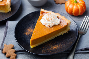 Pumpkin pie, tart with whipped cream on a plate