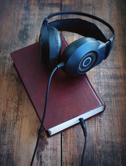 Books and headphones. Concept of listening to audiobooks.