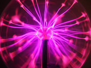 Purple and pink Plasma filaments in plasma globe or ball