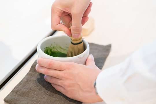 Tea master make matcha tea with tea whisk
