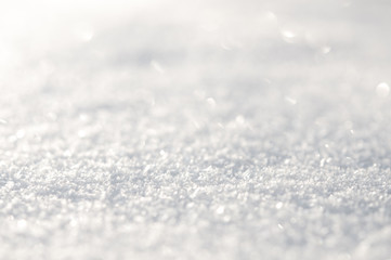 White snow surface close up and flakes background