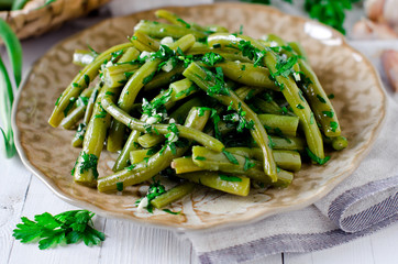 Salad of green beans with garlic, parsley and cilantro