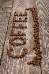 the word coffee made from coffee beans on wooden background