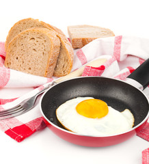 In the course of making breakfast with fresh eggs, on a white ba