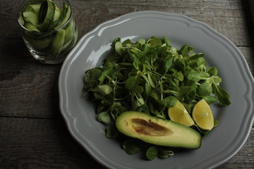 vegan salad with cucumber, lentil, avocado on a gray plate. healthy eating every day.