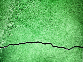 surface of cracks on old and dirty green concrete wall for backg