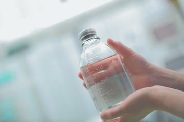 Medicine bottle in hands of health worker