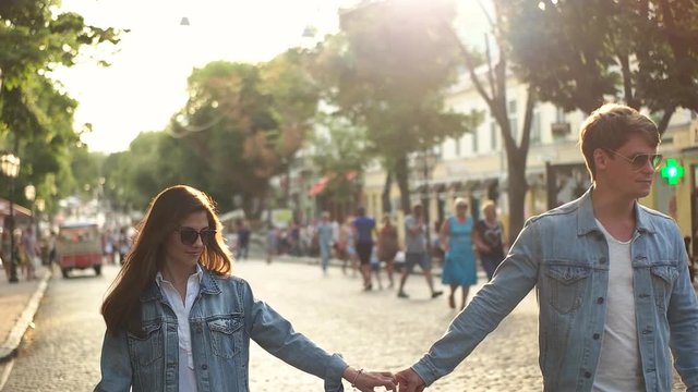 couple in denim shirts walking in the city.