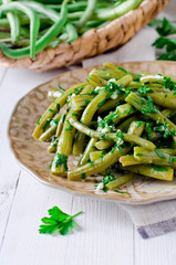 Salad of green beans with garlic, parsley and cilantro