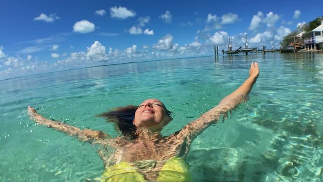 Woman in bikini have fun on the exotic waters, Exuma, Bahamas