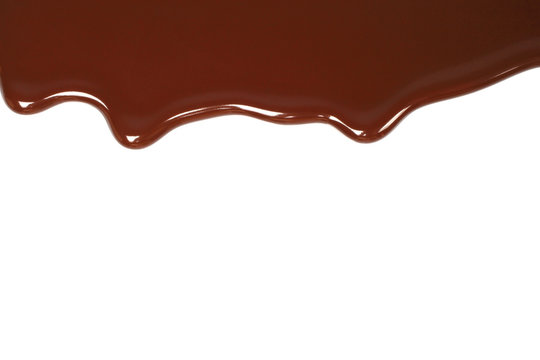 Melted chocolate dripping on white background .