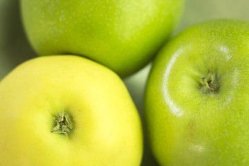 Three green apples on dish