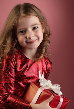 Happy Little girl with red gift box, child holding a gift from S