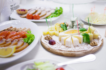 Appetizers. Various types of cheese, salami and prosciutto. Decorated table, buffet