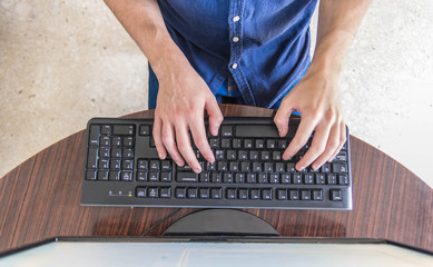 Man working at home office hand on keyboard - obrazy, fototapety, plakaty