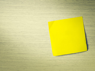 Yellow sticker note on wooden wall