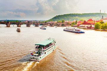 Fototapeta premium Panorama of Prague. View of the Old Town, the Charles Bridge and the river Vltava. Cityscape with dramatic sky. Travel Czech Republic. Europe.
