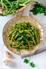 Salad of green beans with garlic, parsley and cilantro