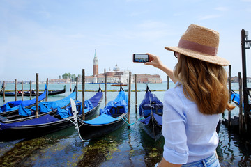 Canal and gondolas with tourist eye