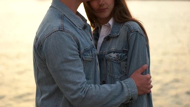 couple in denim on the city waterfront.