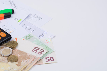 Fototapeta premium Utility or mortgage bills, calculator and Euro banknote and coins