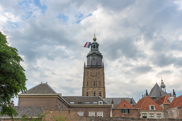 Medieval church with dutch flag half mast