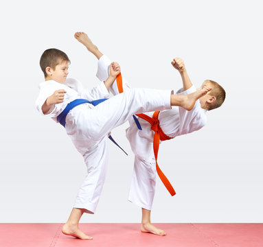 With orange and blue belt the boys are beating kicks legs