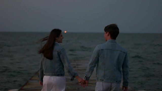 couple walking on the sea berth.