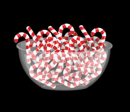 Mint Christmas candy in bowl. Peppermint stick deep in transpare