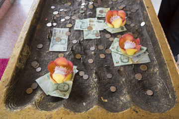 Coin donation in the Buddha's footprint,Sangkhlaburi, Kanchanaburi , Thailand