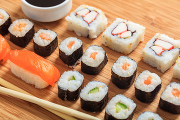 Sushi rolls on wooden surface