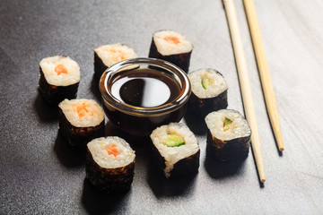 Sushi rolls on a black surface