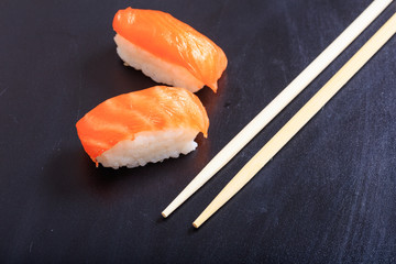 Nigiri salmon on black background