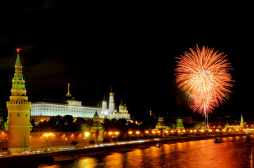Fototapeta na wymiar Flashes of orange and white fireworks near Moscow Kremlin