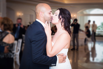 bride and groom dancing and kissing
