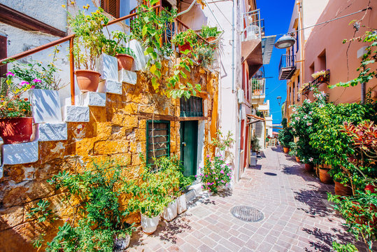Fototapeta Pictoresque mediterranean street with stairs and flower pots, Chania, island of Crete, Greece