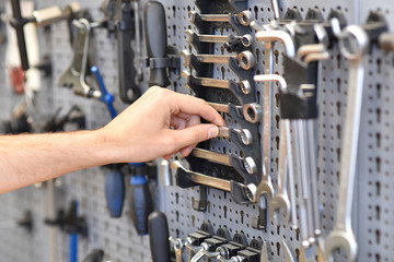Hand eines Mechanikers greift nach Werkzeug zur Reparatur