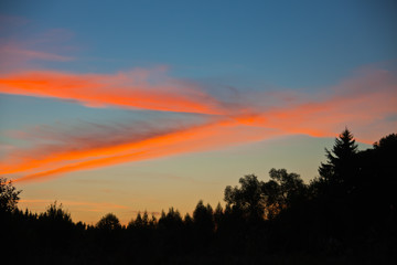 Clouds at sunrise colored sun rays