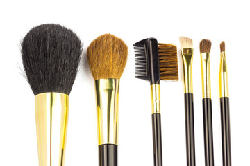 Professional cosmetic brushes for makeup on white background.