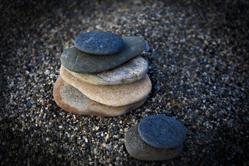 Fototapeta na wymiar Zen stones balance on beach for perfect meditation 