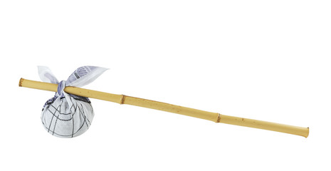 knapsack on a bamboo pole isolated on white