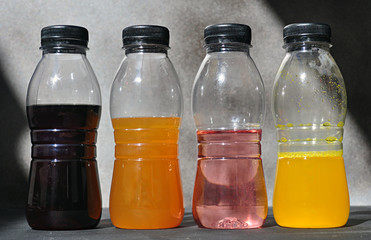 plastic bottles with colored liquid